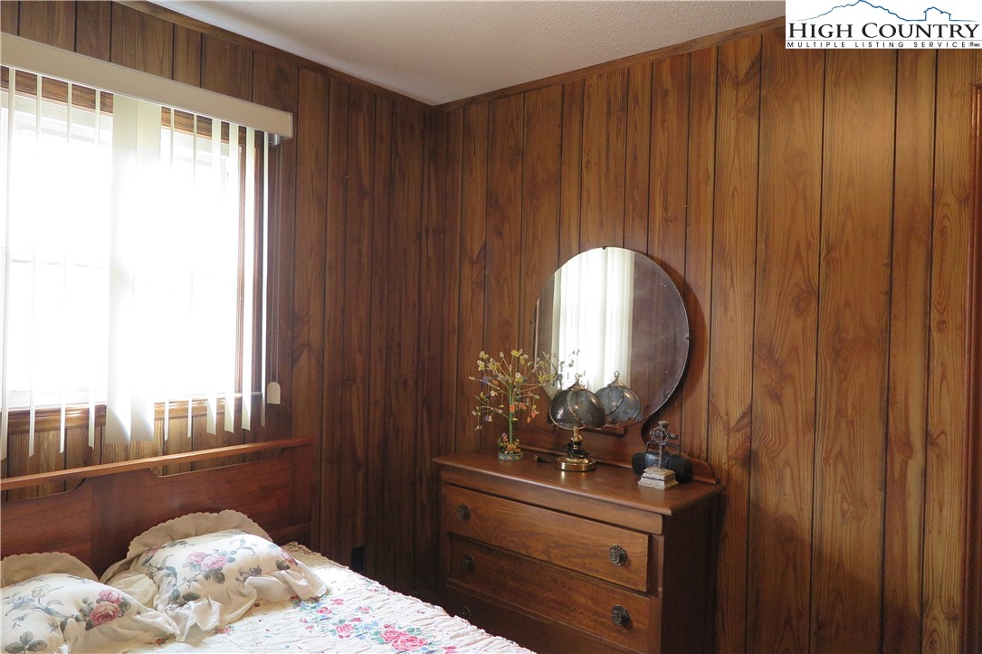134 Carson Boulevard Sparta, NC 28675 - Photo 10 of 15 a bedroom with a bed and a dresser