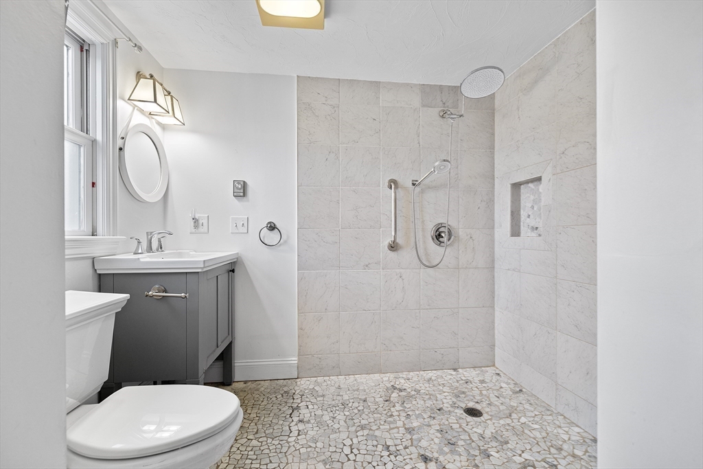 544 Shore Road, Unit 3 Truro, MA 02666 - Photo 22 of 30 a bathroom with a sink a toilet and shower