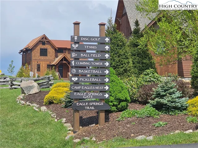 a view of a house with a yard and potted plants