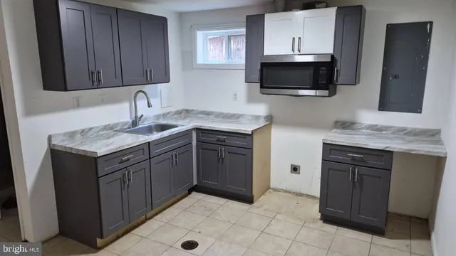 a kitchen with a sink stove and microwave
