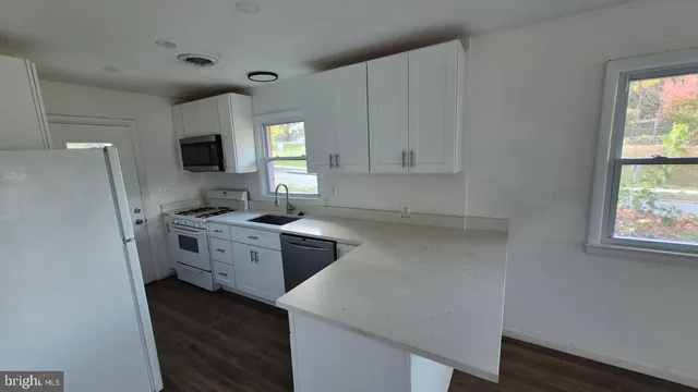 a kitchen with a refrigerator stove and sink