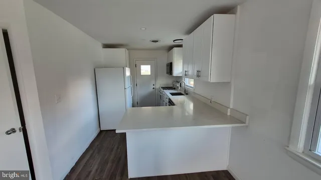 a view of a kitchen from the hallway