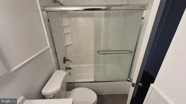 a bathroom with a shower and a toilet