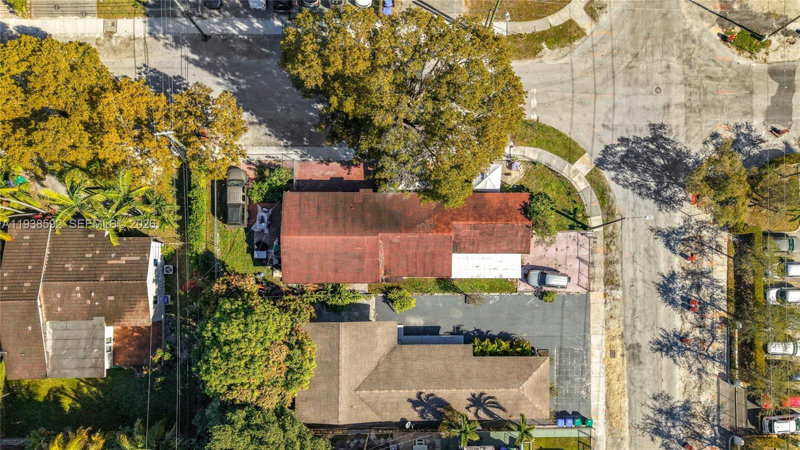 aerial view of a house with a yard and potted plants