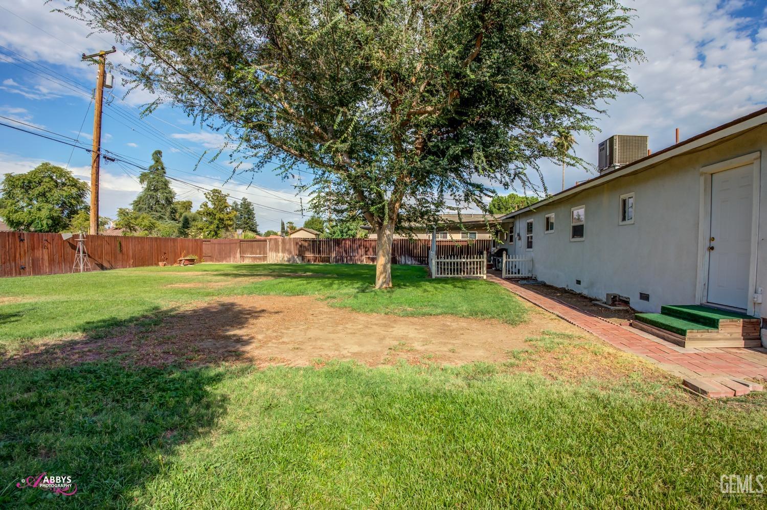 Undisclosed Address Bakersfield, CA 93309 - Photo 16 of 33 a backyard of a house with lots of green space