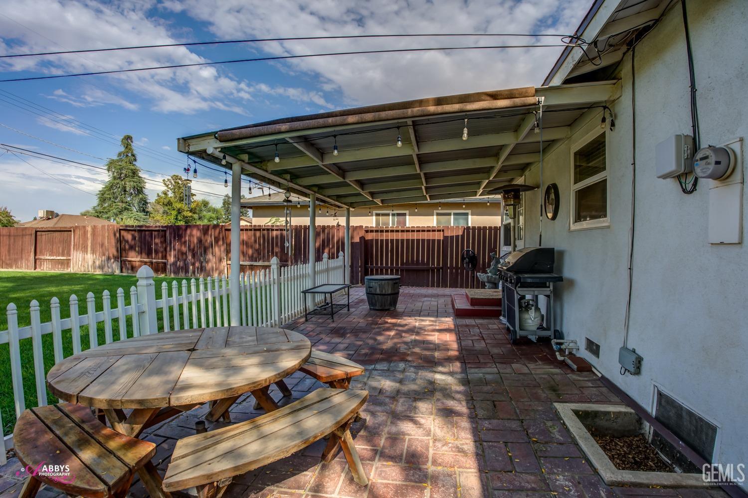 Undisclosed Address Bakersfield, CA 93309 - Photo 17 of 33 a view of a patio with table and chairs with wooden floor