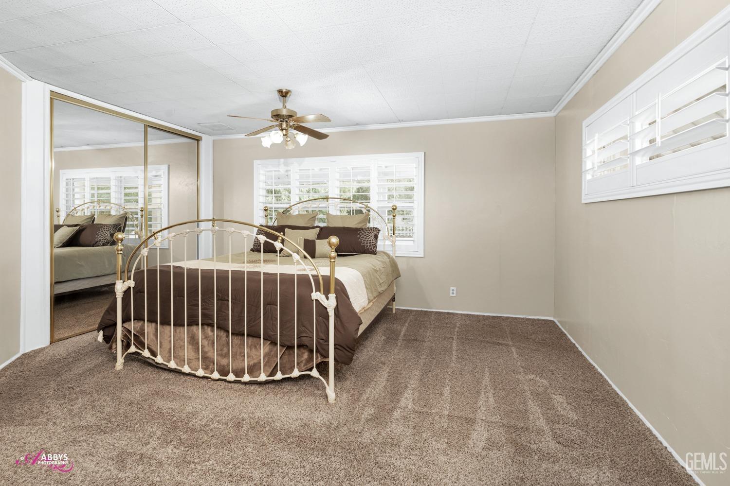 Undisclosed Address Bakersfield, CA 93309 - Photo 19 of 33 a bed room with a bed and a chandelier