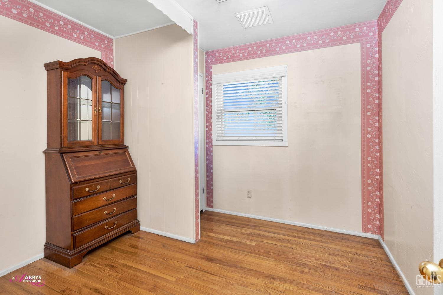 Undisclosed Address Bakersfield, CA 93309 - Photo 22 of 33 an empty room with wooden floor closet and windows