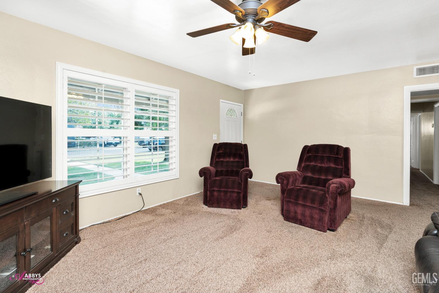Undisclosed Address Bakersfield, CA 93309 - Photo 26 of 33 a living room with furniture and a flat screen tv