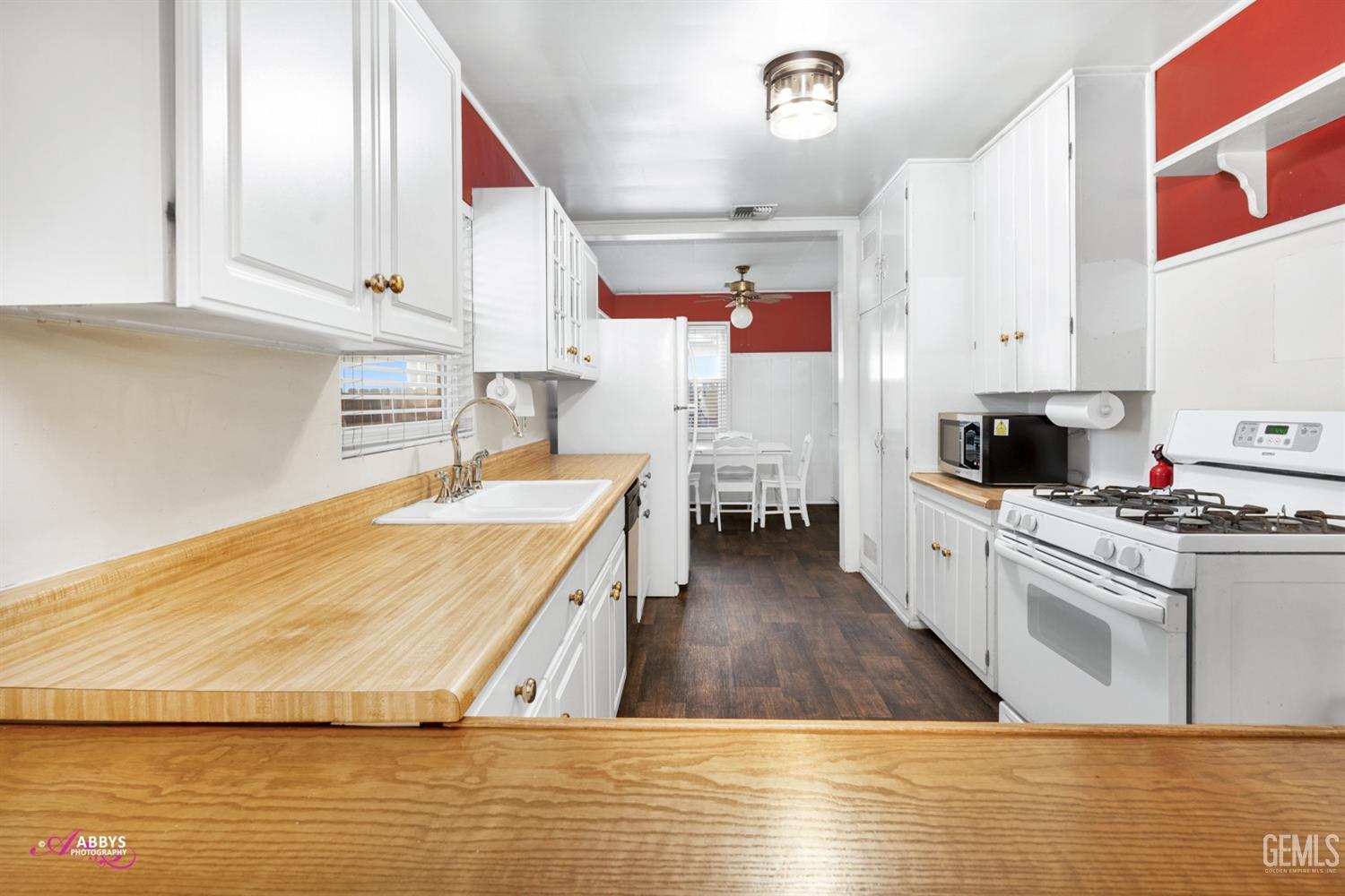 Undisclosed Address Bakersfield, CA 93309 - Photo 29 of 33 a living room with stainless steel appliances kitchen island granite countertop a stove and a sink