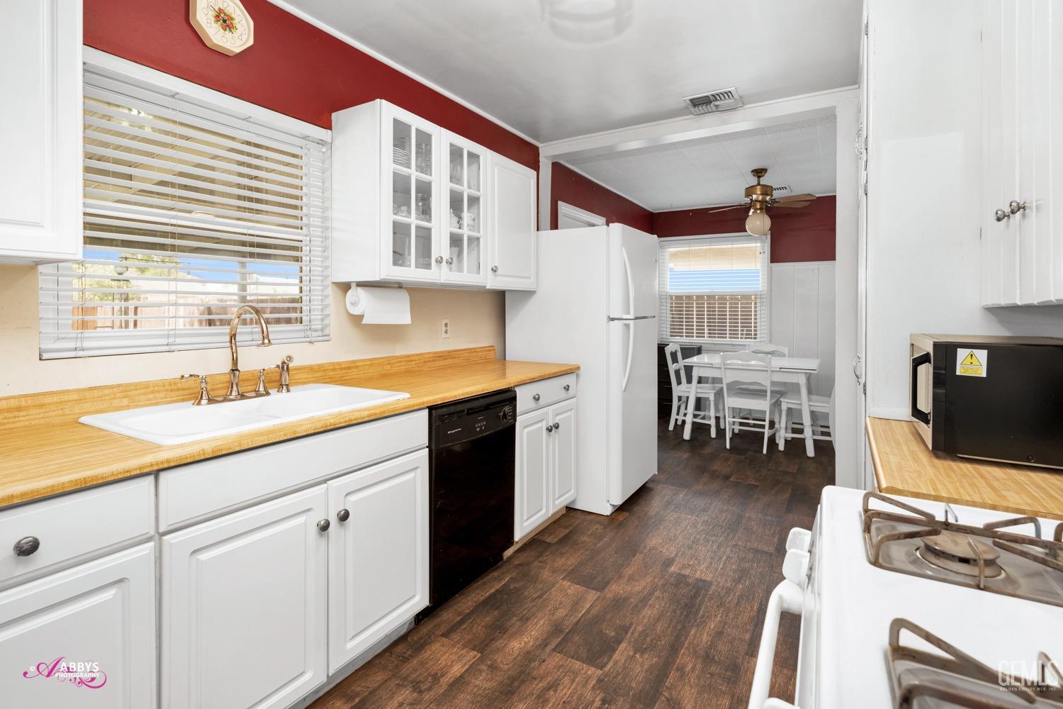 Undisclosed Address Bakersfield, CA 93309 - Photo 30 of 33 a kitchen with a sink cabinets and wooden floor