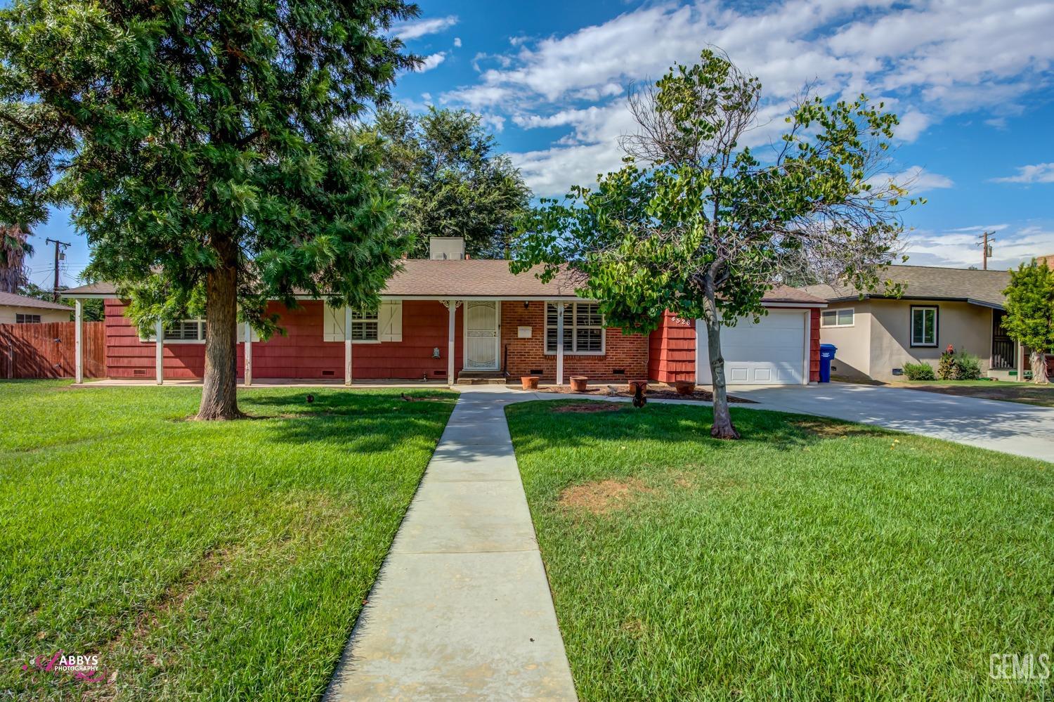 Undisclosed Address Bakersfield, CA 93309 - Photo 3 of 33 a front view of a house with a yard