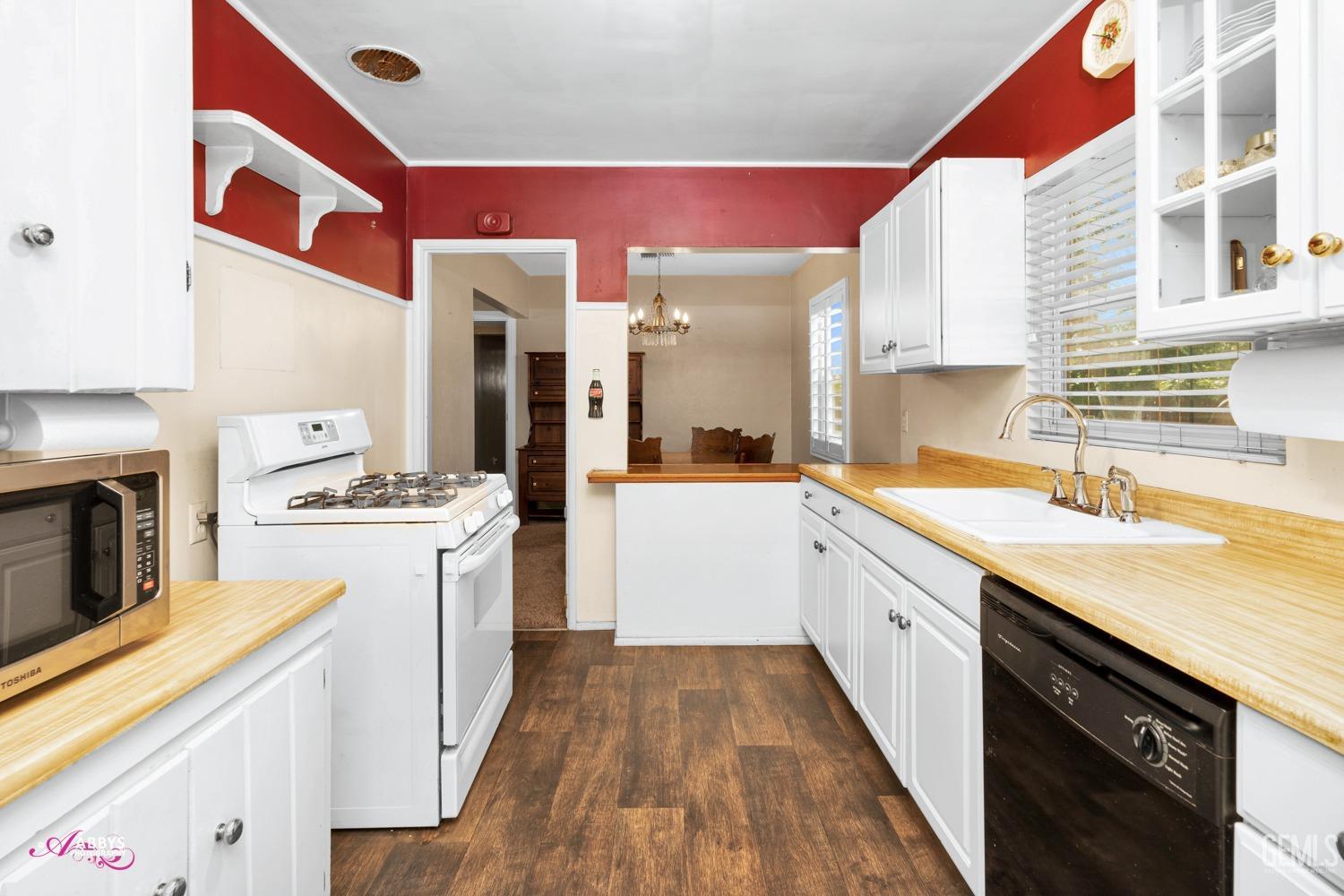 Undisclosed Address Bakersfield, CA 93309 - Photo 32 of 33 a kitchen with a stove a sink and a refrigerator