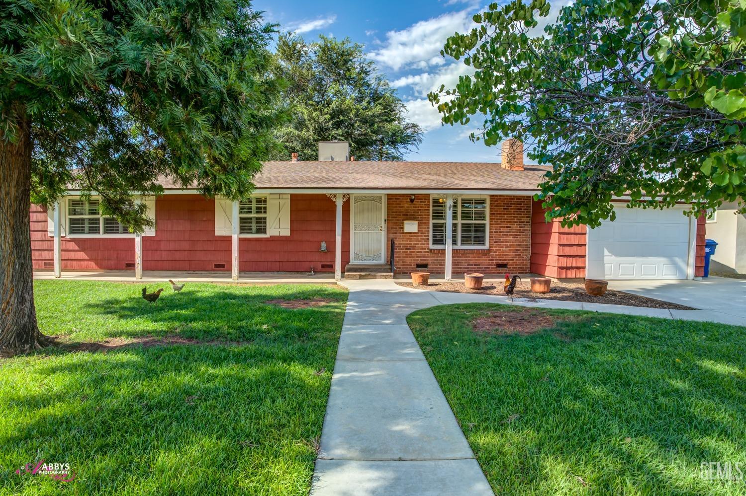 Undisclosed Address Bakersfield, CA 93309 - Photo 6 of 33 a front view of a house with yard patio and green space