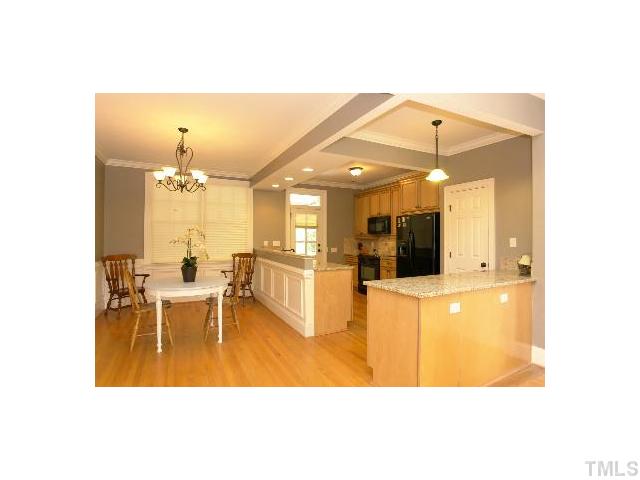 1115 Wake Forest Road, Unit D Raleigh, NC 27604 - Photo 5 of 24 a view of a dining room with furniture and a chandelier