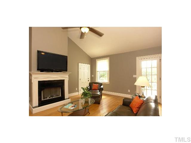 1115 Wake Forest Road, Unit D Raleigh, NC 27604 - Photo 7 of 24 a living room with furniture a fireplace and a flat screen tv