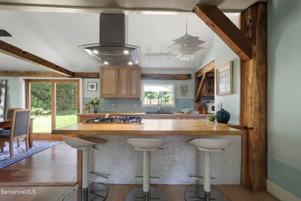 a view of kitchen with dining area and chandelier