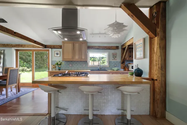 a view of kitchen with dining area and chandelier