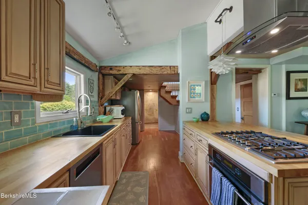 a kitchen with stainless steel appliances granite countertop a stove and a sink