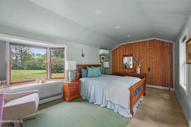 a bedroom with a bed and a large window