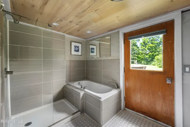 a bathroom with a bathtub and shower
