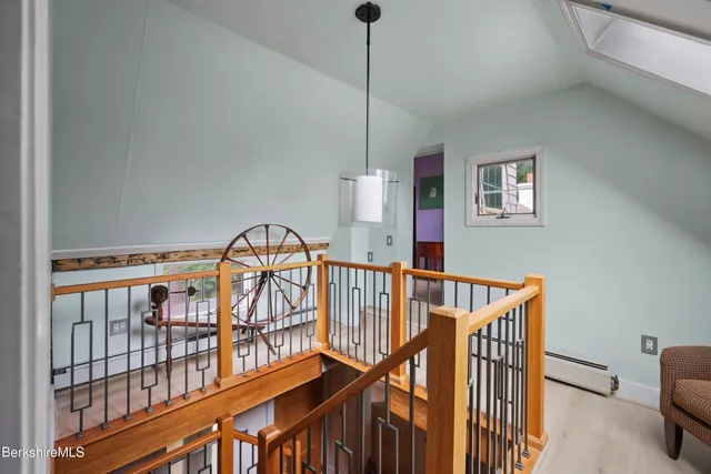 a view of staircase with furniture and a window