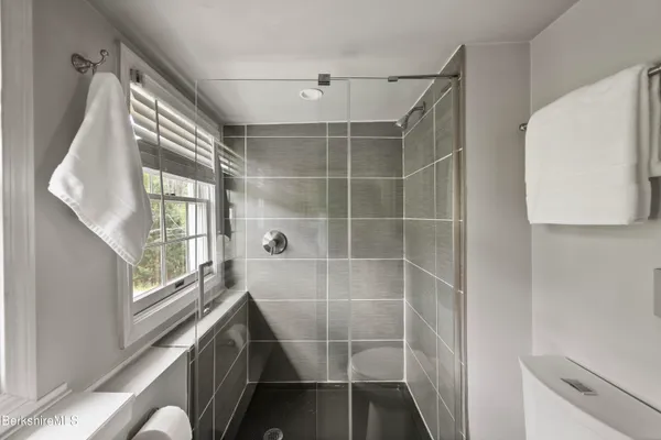 a bathroom with a shower and a sink