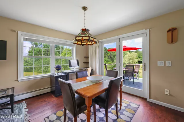 a dining room with furniture a chandelier and wooden floor