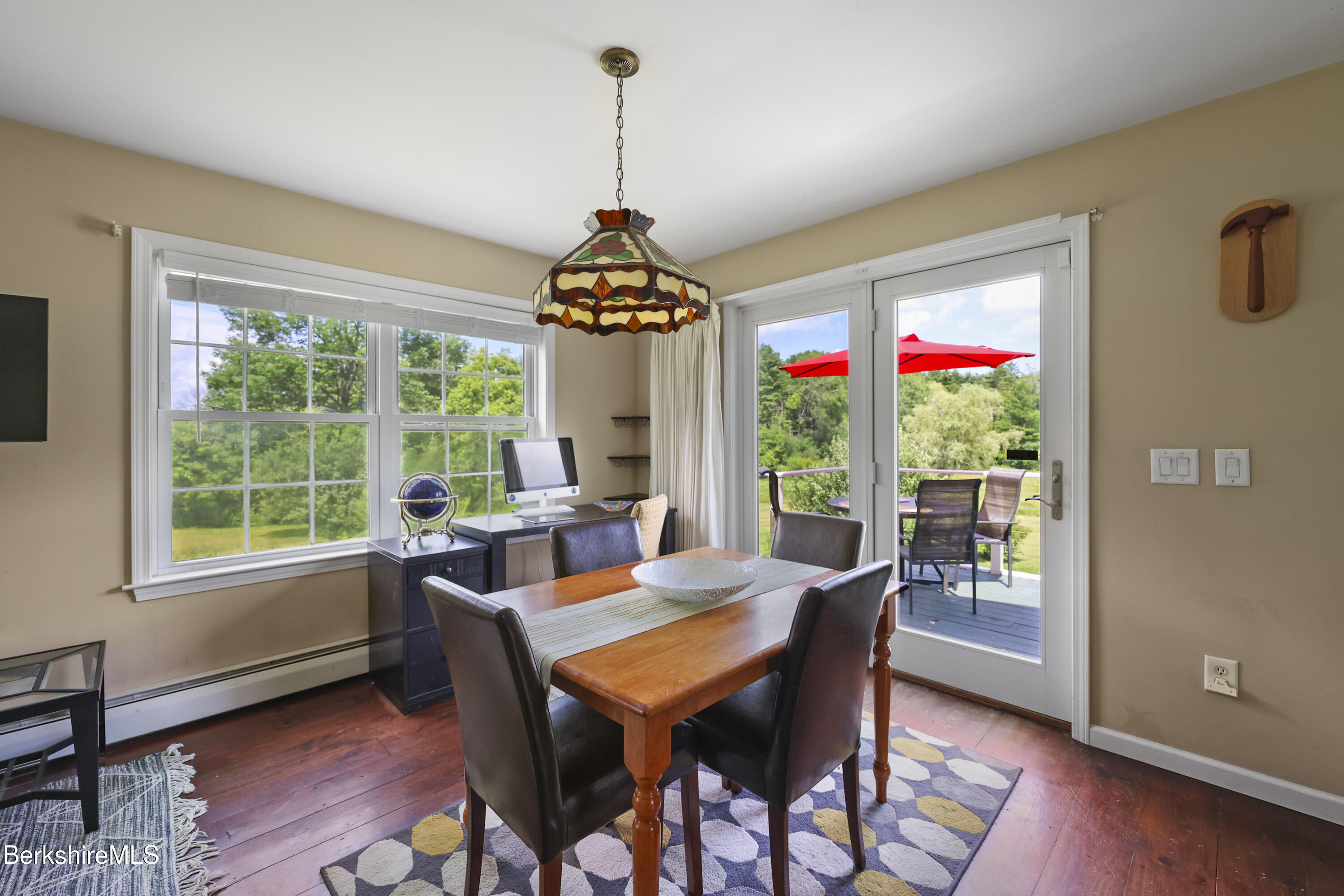 9 Castle Hill Road Stockbridge, MA 01262 - Photo 34 of 47 a dining room with furniture a chandelier and wooden floor