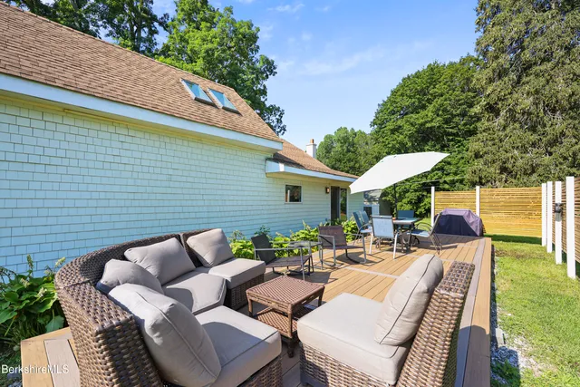 a view of a patio with couches chairs and a fire pit