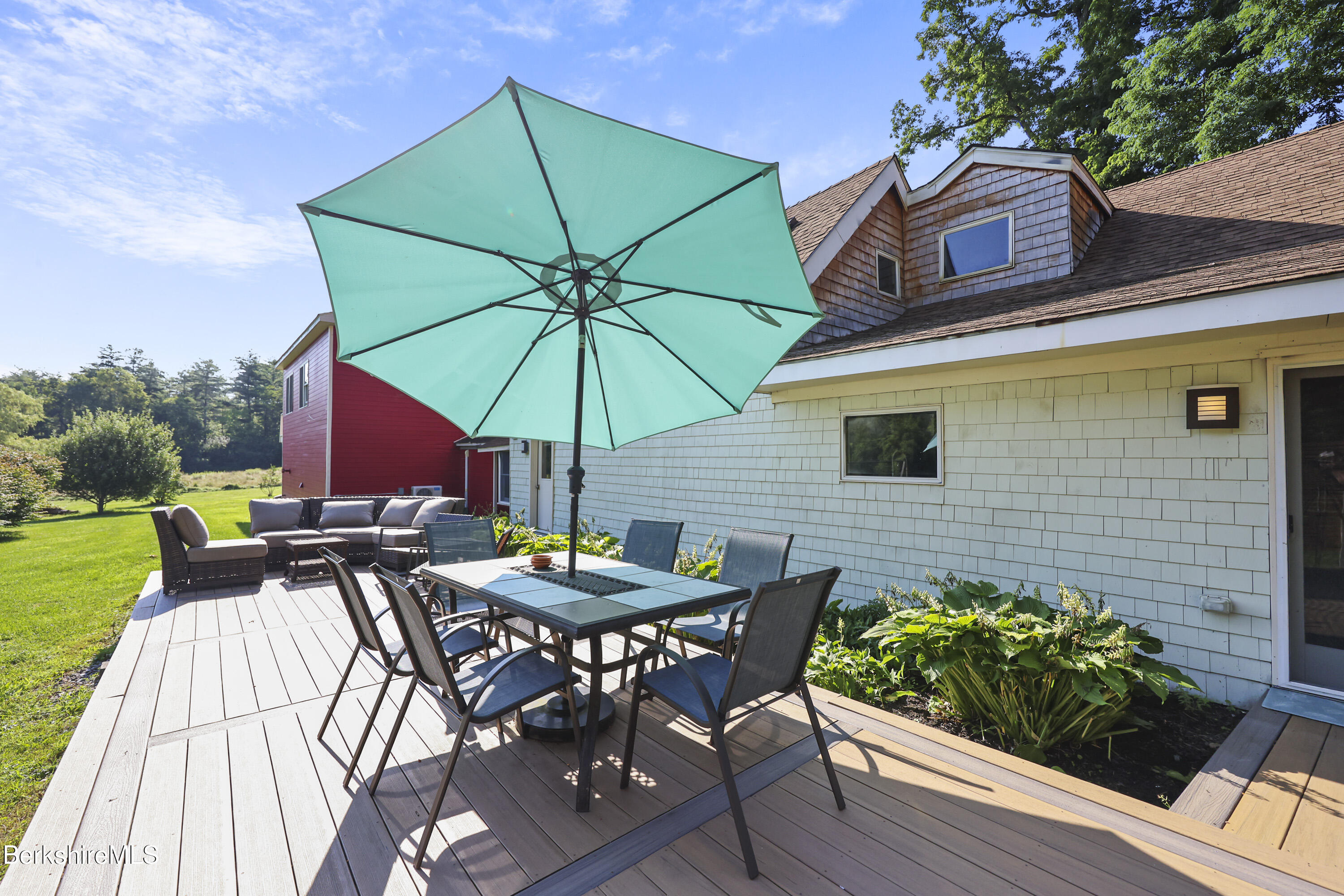 9 Castle Hill Road Stockbridge, MA 01262 - Photo 43 of 47 a view of deck with patio table and chairs under an umbrella