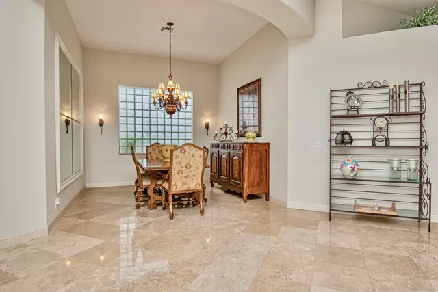 a bedroom with a bed and large window with couch