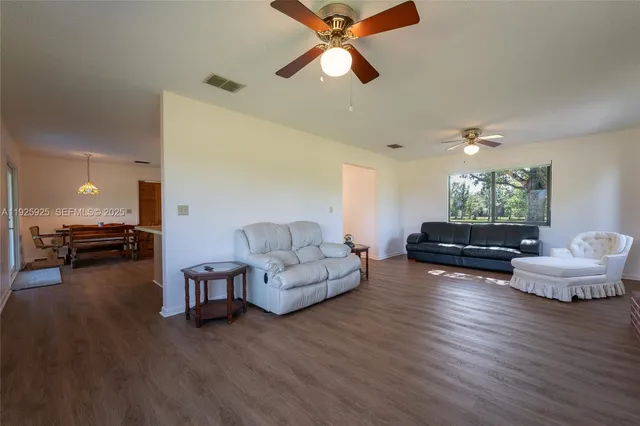 a living room with fireplace furniture and a wooden floor