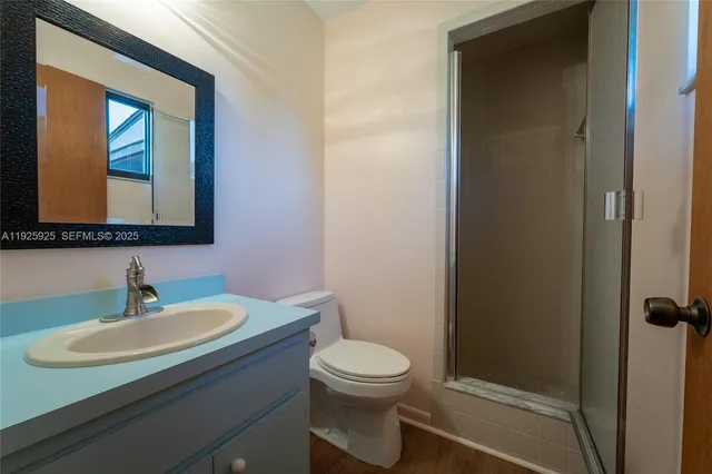 a bathroom with a toilet a sink and mirror