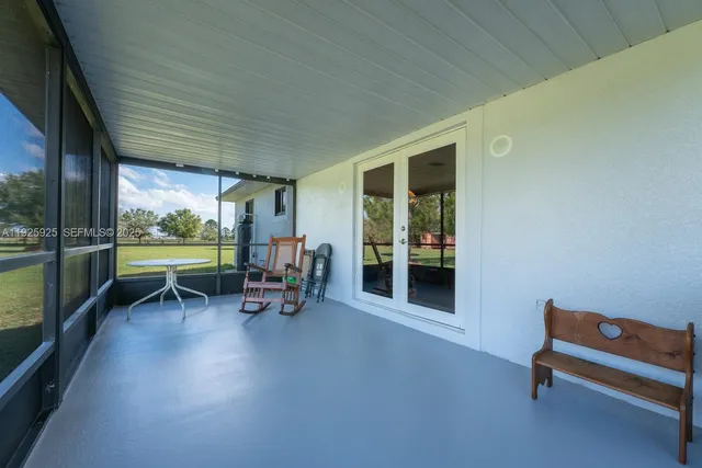 a sitting area with chairs and a table