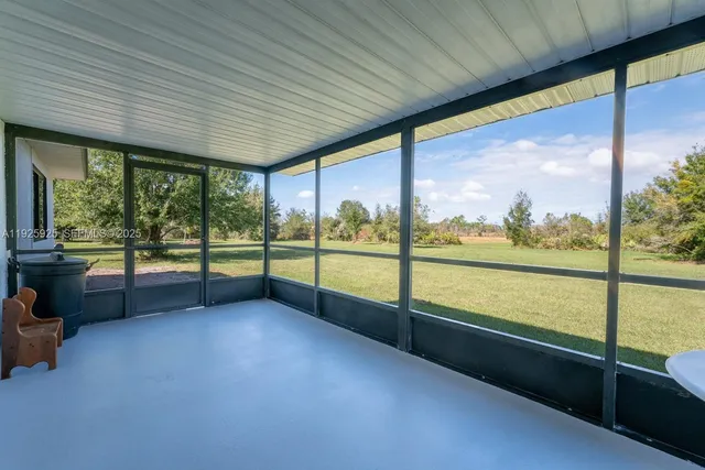 a view of an empty room with a large window