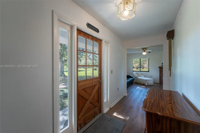 a view of a bedroom with a bed and a window