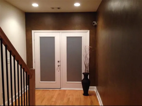 a kitchen with a table chairs refrigerator and microwave