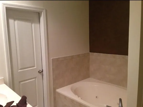 a open kitchen with stainless steel appliances wooden cabinets and a refrigerator