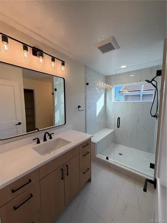 a bathroom with a tub sink and mirror