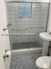 a bathroom with a toilet and a shower
