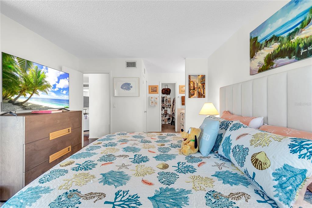 12200 Vonn Road, Unit 2206 Largo, FL 33774 - Photo 28 of 60 a bedroom with a bed and a flat screen tv