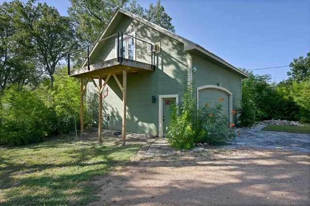 a view of a house with a yard and sitting area