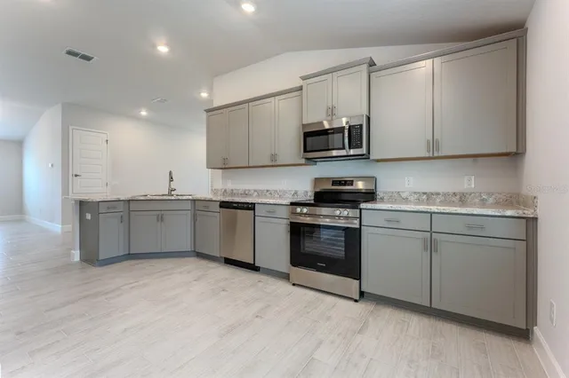 a view of a hallway with stairs and a window