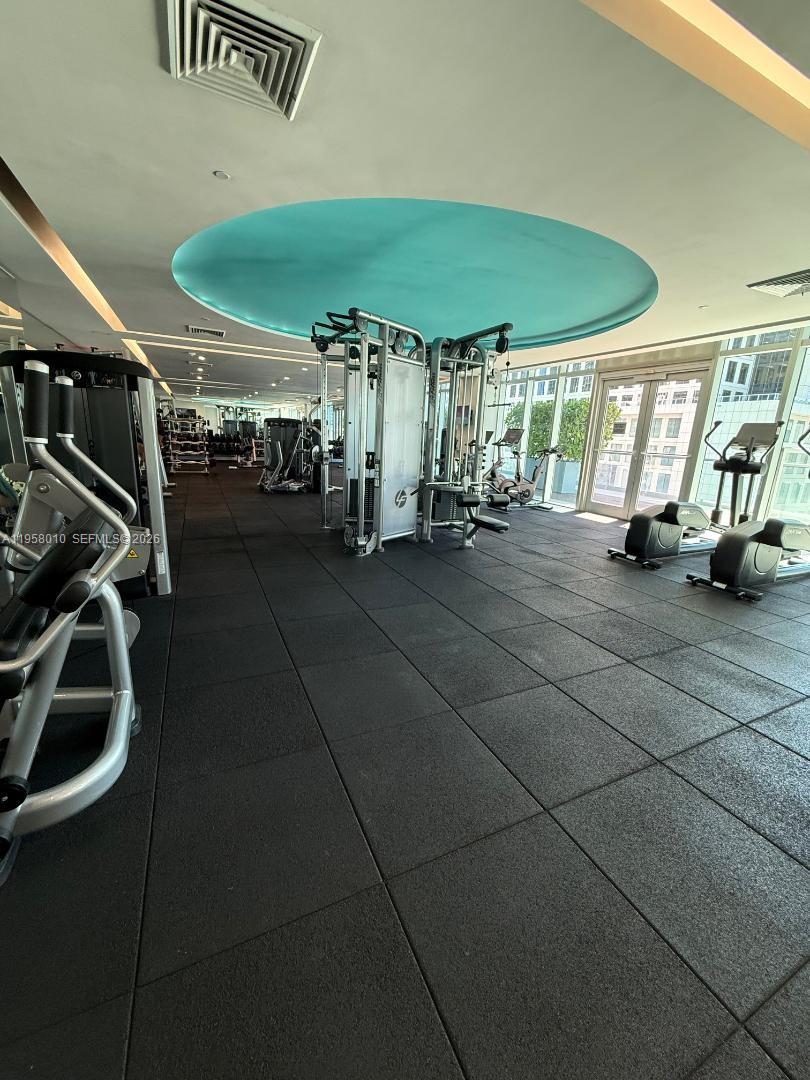 55 Southeast 6th Street, Unit 1807 Miami, FL 33131 - Photo 20 of 23 a view of a room with gym equipment