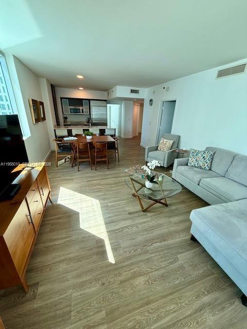 55 Southeast 6th Street, Unit 1807 Miami, FL 33131 - Photo 3 of 23 a living room with furniture and a couch