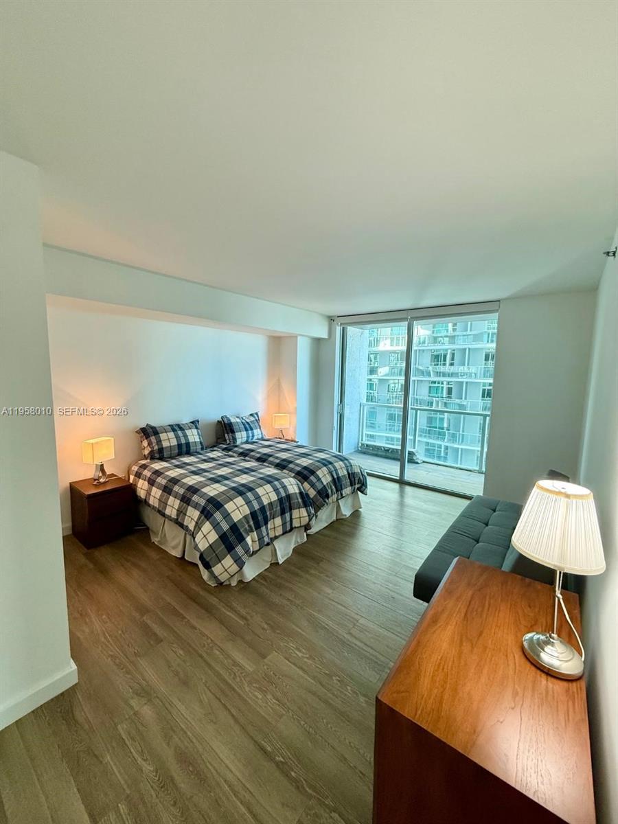 55 Southeast 6th Street, Unit 1807 Miami, FL 33131 - Photo 6 of 23 a bedroom with a bed and a window