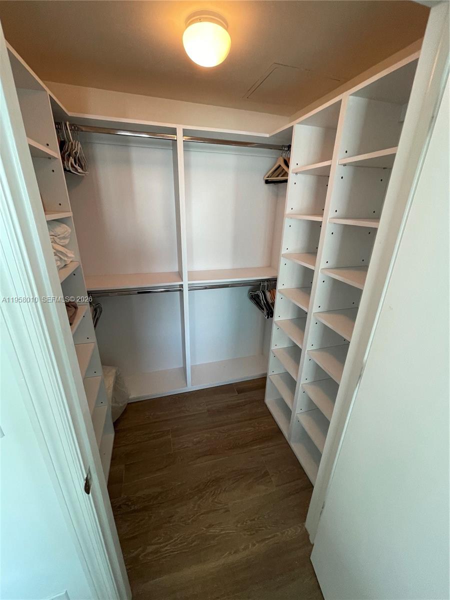 55 Southeast 6th Street, Unit 1807 Miami, FL 33131 - Photo 9 of 23 a view of walk in closet with empty racks