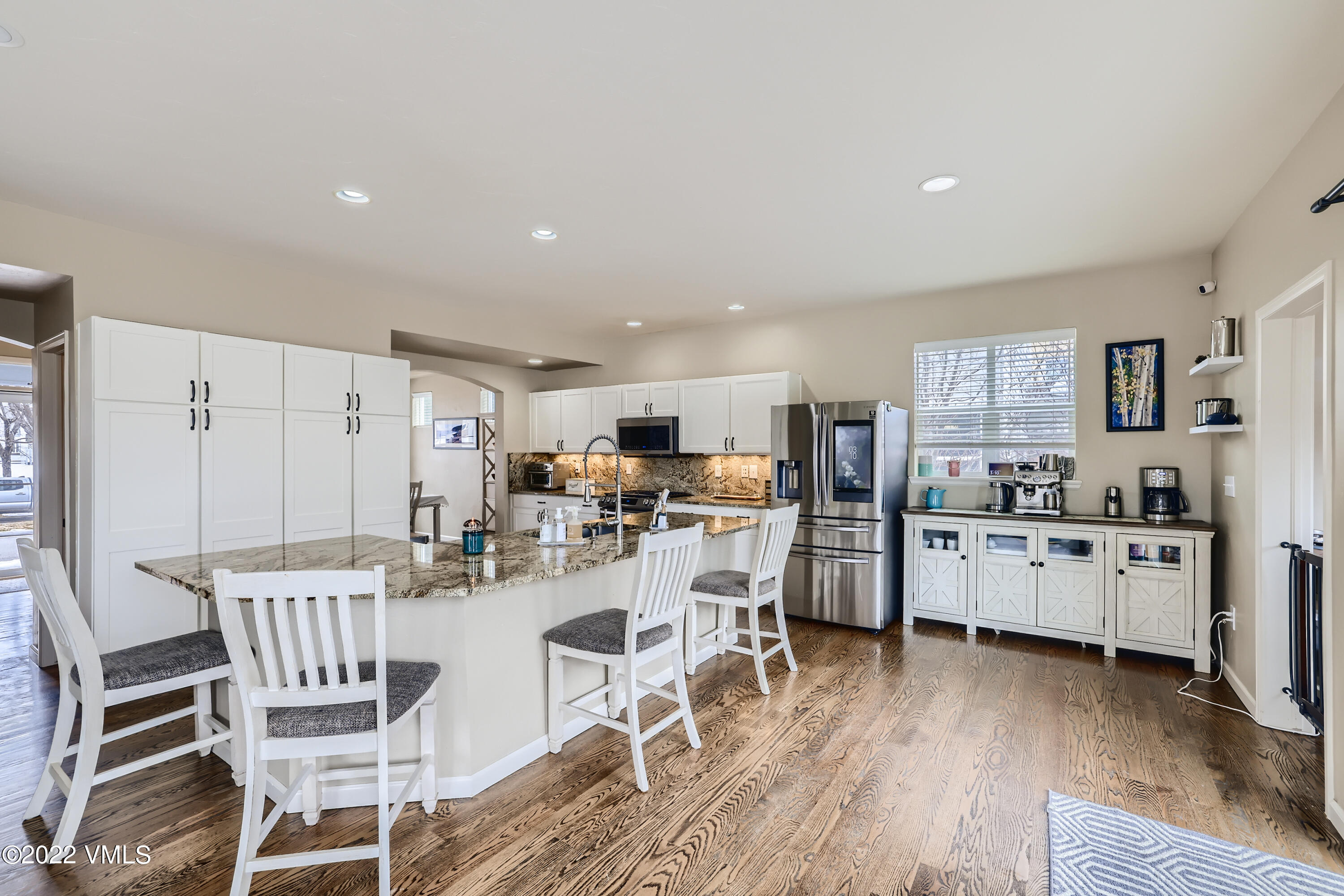 279 Longview Avenue Eagle, CO 81631 - Photo 8 of 30 a kitchen with stainless steel appliances kitchen island granite countertop a dining table chairs and granite counter tops