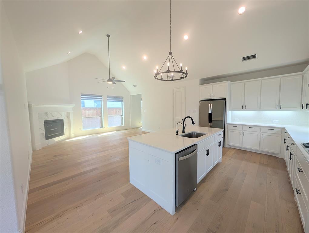 15532 Fringe Tree Road Frisco, TX 75035 - Photo 6 of 31 Open-concept kitchen and living area featuring wood-finish flooring